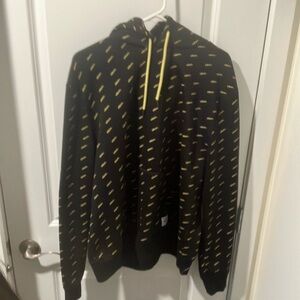 Black pull-over hoodie, with the word “vibes.” Written in yellow all over.